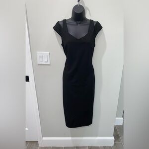 Last chance for this flattering Black dress with unique neckline